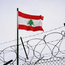 Lebanon flag in barbed wire, sanctions and aggression of Lebanon